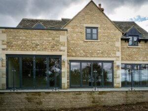 Fully glazed rear of a new country side home including glazed railing