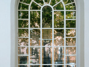 Arched German timber window with shaped glazing bars