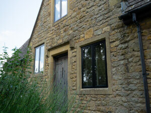 Costswold stone home with thin frame aluminium windows and stone mullions