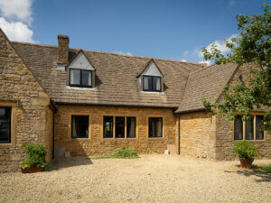 Cotswold stone home with Aluminium Heritage dormer windows