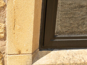 Low profile aluminium windows fitted in stone mullions