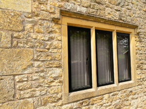 RAL 9005 Jet Black aluminium heritage windows in stone mullions