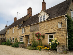 Cotswold stone home with RAL 9001 Cream White windows
