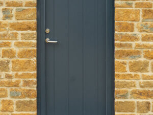 Rationel Entrance door on black brick cill