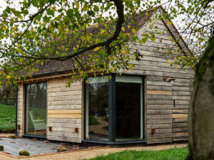 timber clad outhouse with RAL 7016 Anthracite grey windows