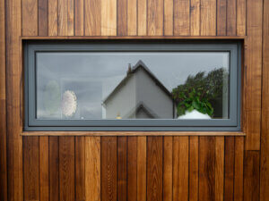 Topguided STM Tinium window in timber clad home
