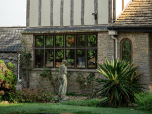 Black aluminium windows in tudor style home with oak surrounds
