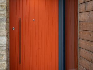 Bold orange panel door with vertical grooves 