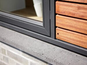 Granite finish windows beside timber slats 