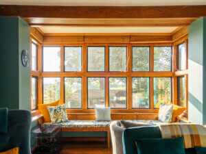 Inside an oak post bay window with slim aluminium window frames
