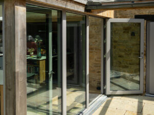 STM aluminium clad double fixedlight with outward opening entrance door