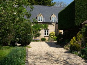 Cotswold stone home with sidehung windows and a single horizontal glazing bar