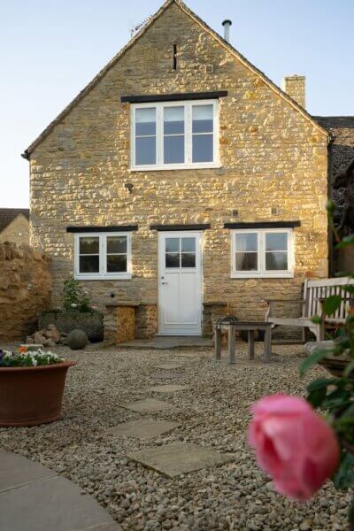 Fixed sash and Sidehung timber windows with a single horizontal glazing bar in a cotswold stone home